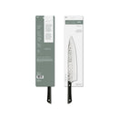A kitchen knife shown in its retail packaging, with the knife partially visible through a clear window next to the box.
