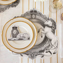A place setting featuring regal unicorn placemat and lion wearing a crown place card.