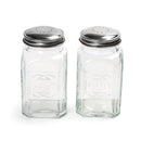 A set of two clear glass salt and pepper shakers with stainless steel lids, marked with 'Salt' and 'Pepper' on the front.