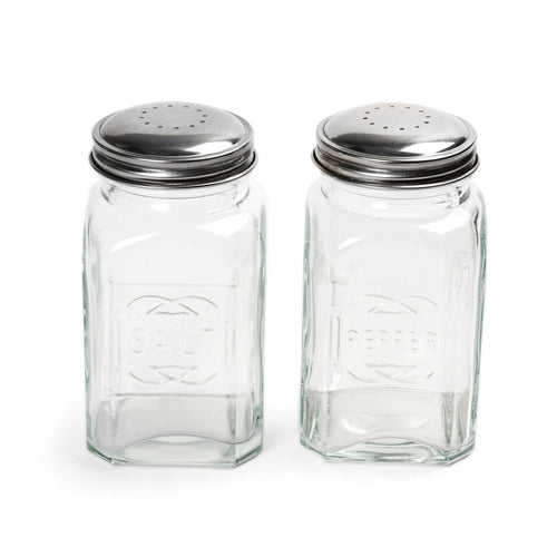 A set of two clear glass salt and pepper shakers with stainless steel lids, marked with 'Salt' and 'Pepper' on the front.
