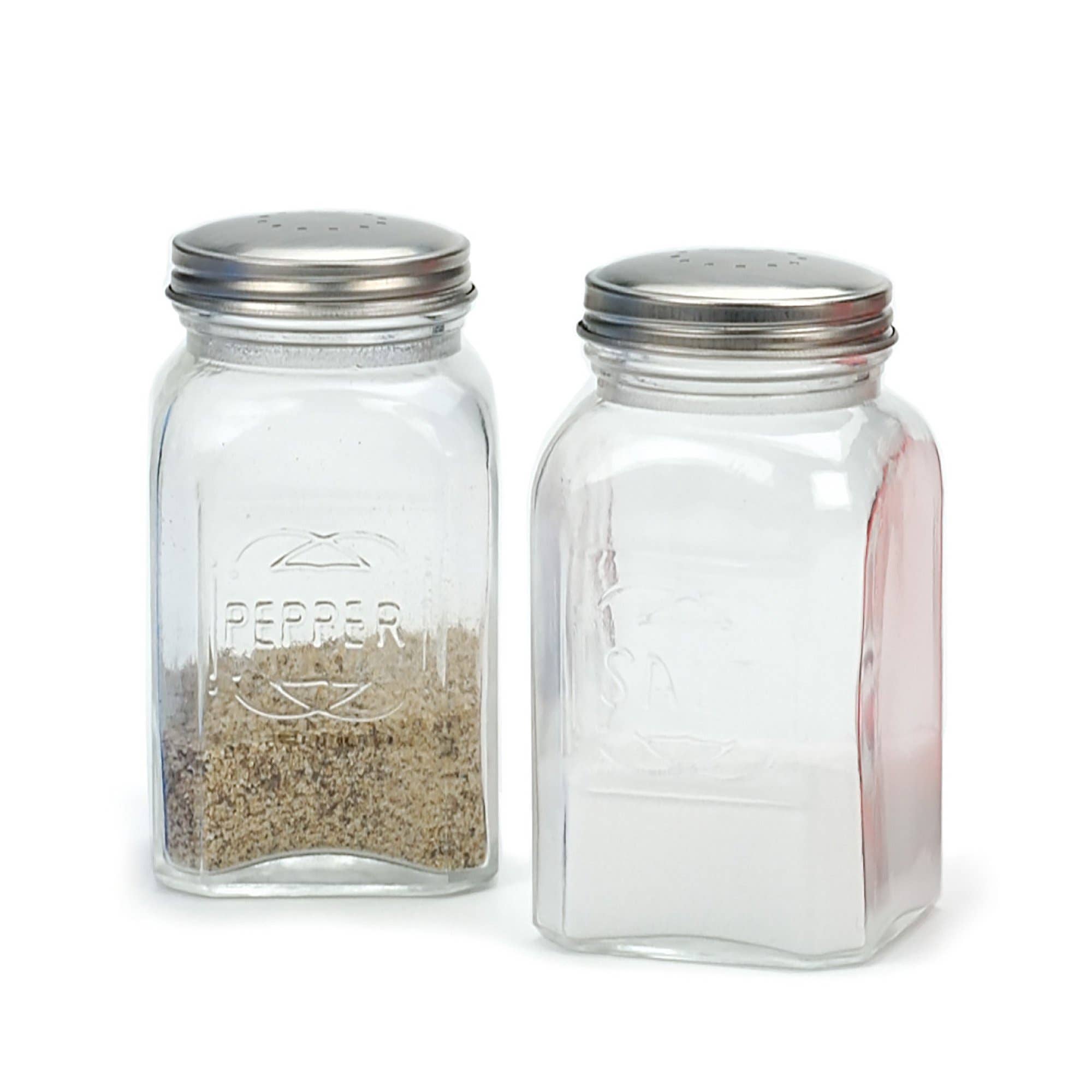 A salt and pepper shaker set filled partway with pepper and salt on a white background.