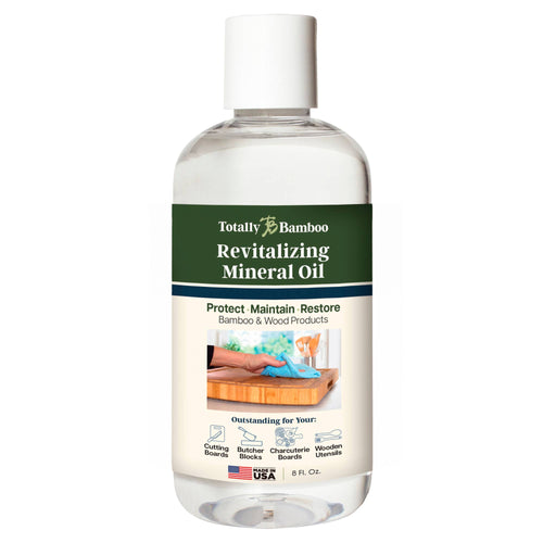 Bottle of Totally Bamboo revitalizing mineral oil on a white background