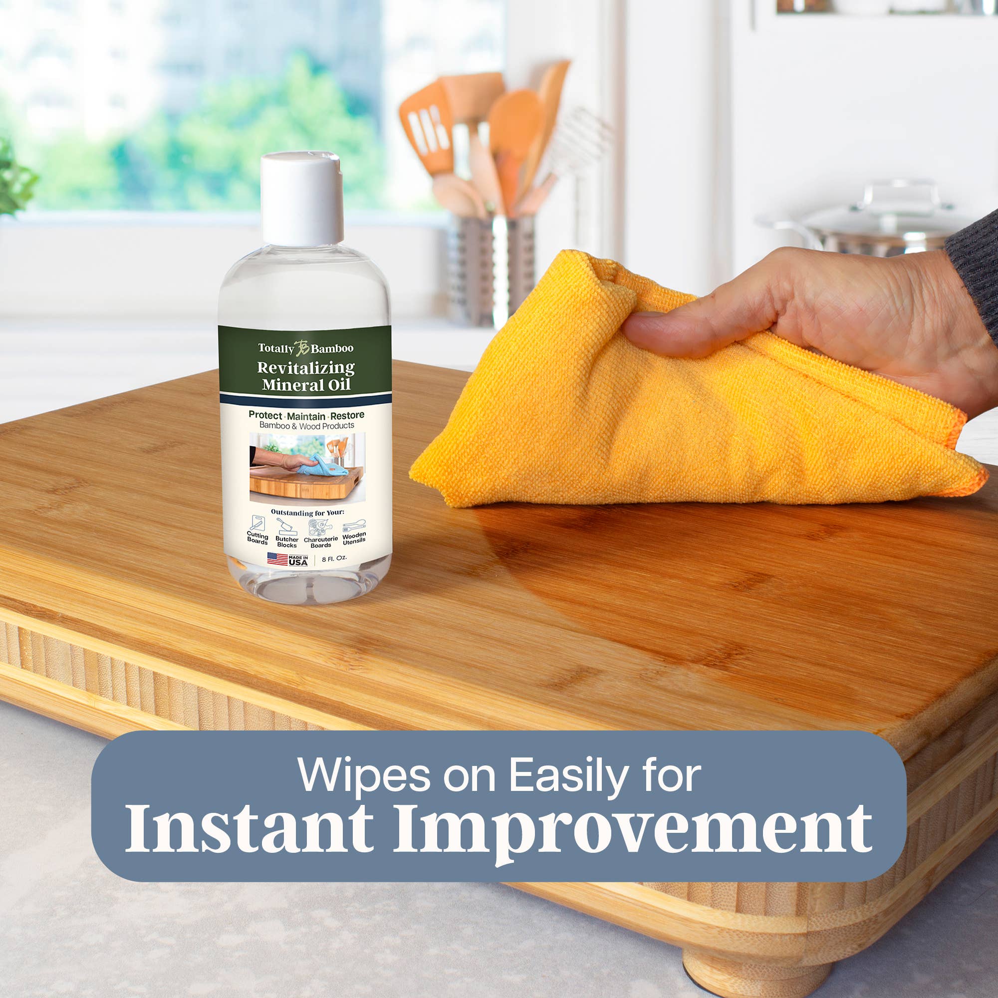 Bottle of Totally Bamboo Revitalizing Mineral Oil with a yellow cloth on a wooden surface, with text 'Wipes on Easily for Instant Improvement'.
