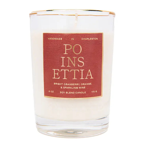 A poinsettia scented candle with red labeling on a white background.