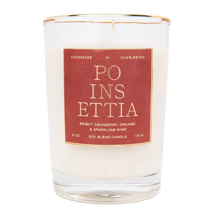 A poinsettia scented candle with red labeling on a white background.