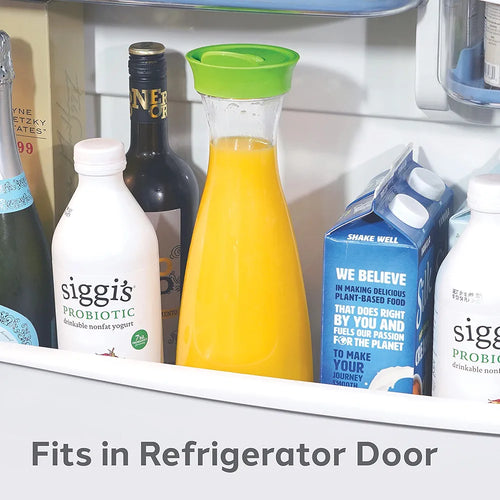 Fridge door with yogurt, orange juice in a carafe, and other items.
