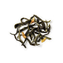 Dry green tea leaves on a white background