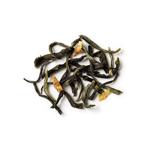 Dry green tea leaves on a white background