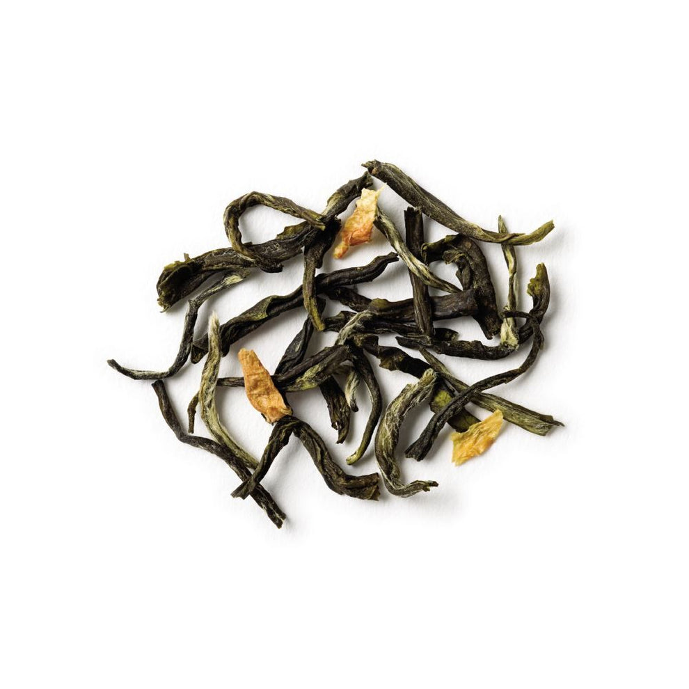 Dry green tea leaves on a white background