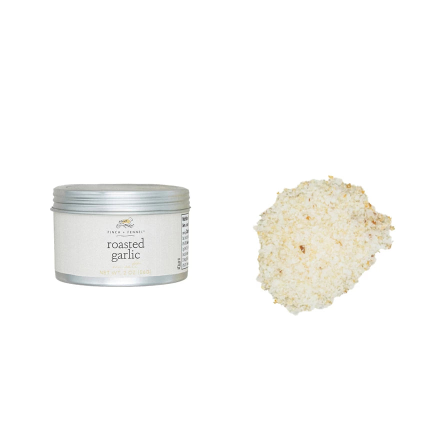 Tin of roasted garlic powder with a scoop of the powder on a white background