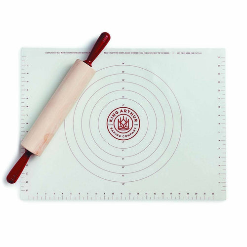 Baking mat with circular measurements and a rolling pin on a white background, featuring the King Arthur Baking Company logo.