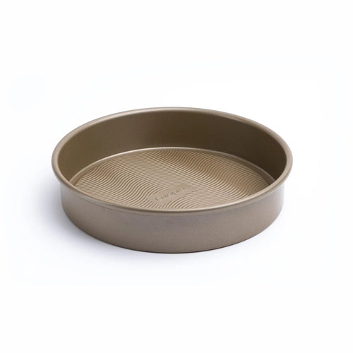 Round beige baking pan on a white background