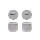 Two stoneware pinch pots, one labeled 'salt' and the other 'pepper', against a white background.