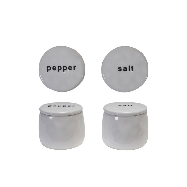 Two stoneware pinch pots, one labeled 'salt' and the other 'pepper', against a white background.