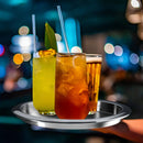 Three iced drinks on a metal tray with a blurred cityscape background
