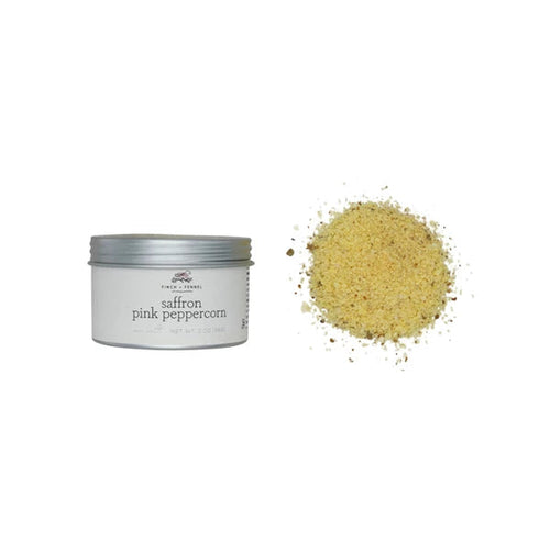 Saffron pink pepper mix in a tin container on a white background