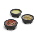Three small black bowls with different sauces on a white background