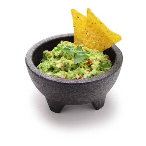Bowl of guacamole with tortilla chips on a white background