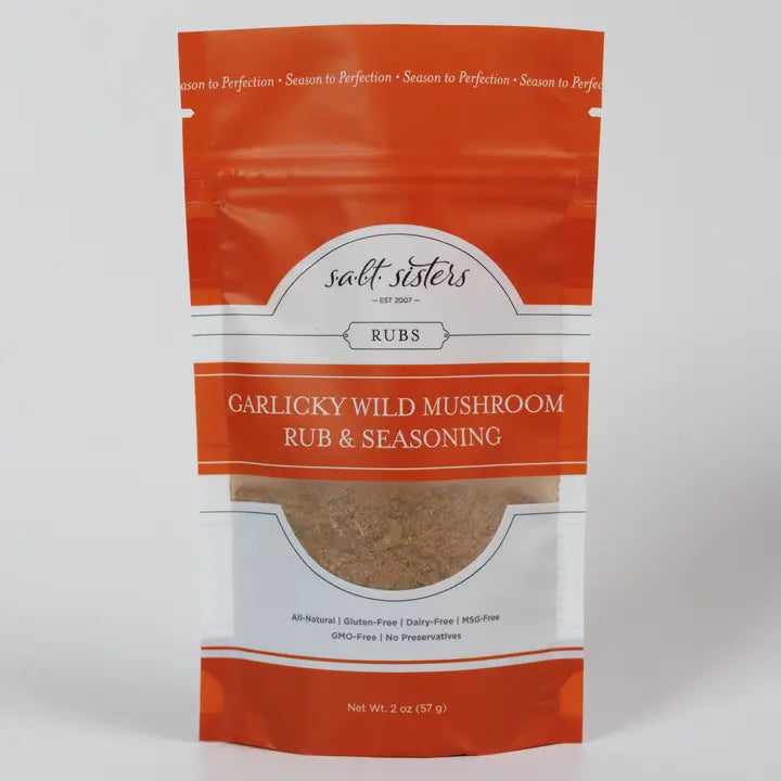 Packaging of Salt Sisters Garlicky Wild Mushroom Rub & Seasoning Mix, showing the product name and a visible sample of the seasoning mix through the clear window.