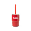 Red tumbler with fancy 'ho ho ho' script with a straw on a white background