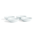 Four small white porcelain bowls on a white background.