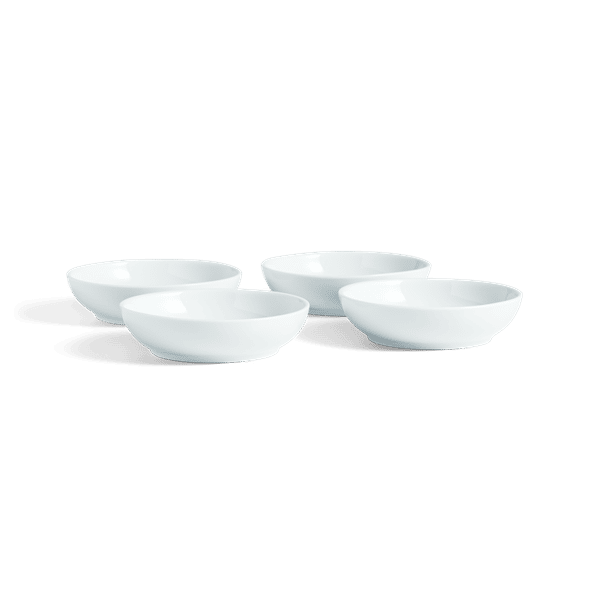 Four small white porcelain bowls on a white background.