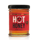 Jar of hot honey with a red label on a white background