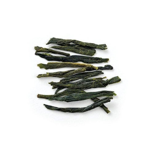 Stack of green tea leaves on a white background