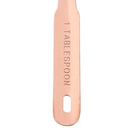 A single copper-colored measuring spoon with '1 TABLESPOON' engraved vertically on the handle, shown against a plain white background.