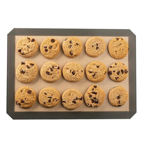 Silicone baking mat with chocolate chip cookies on a white background