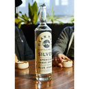 Bottle of Mean Mule Silver American Agave Spirit on a table with a blurred background