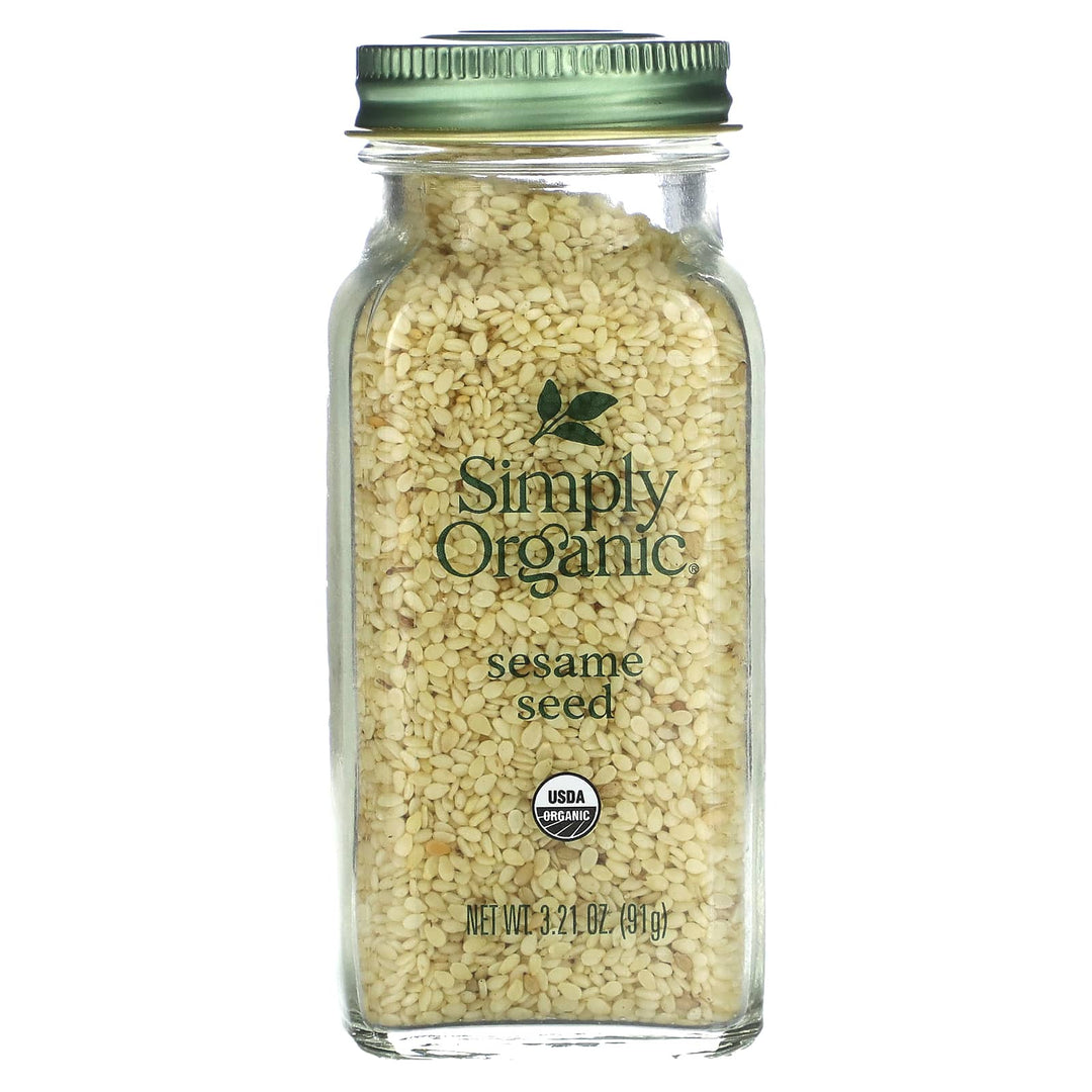 A clear glass jar filled with whole sesame seeds, with a green lid and a label that says 'Simply Organic Sesame Seed'.