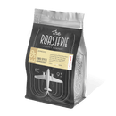 A pack of The Roasterie Euro Style Espresso coffee, showing the brand logo, product name, and a graphic of an airplane on the front.