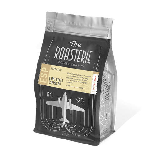 A pack of The Roasterie Euro Style Espresso coffee, showing the brand logo, product name, and a graphic of an airplane on the front.