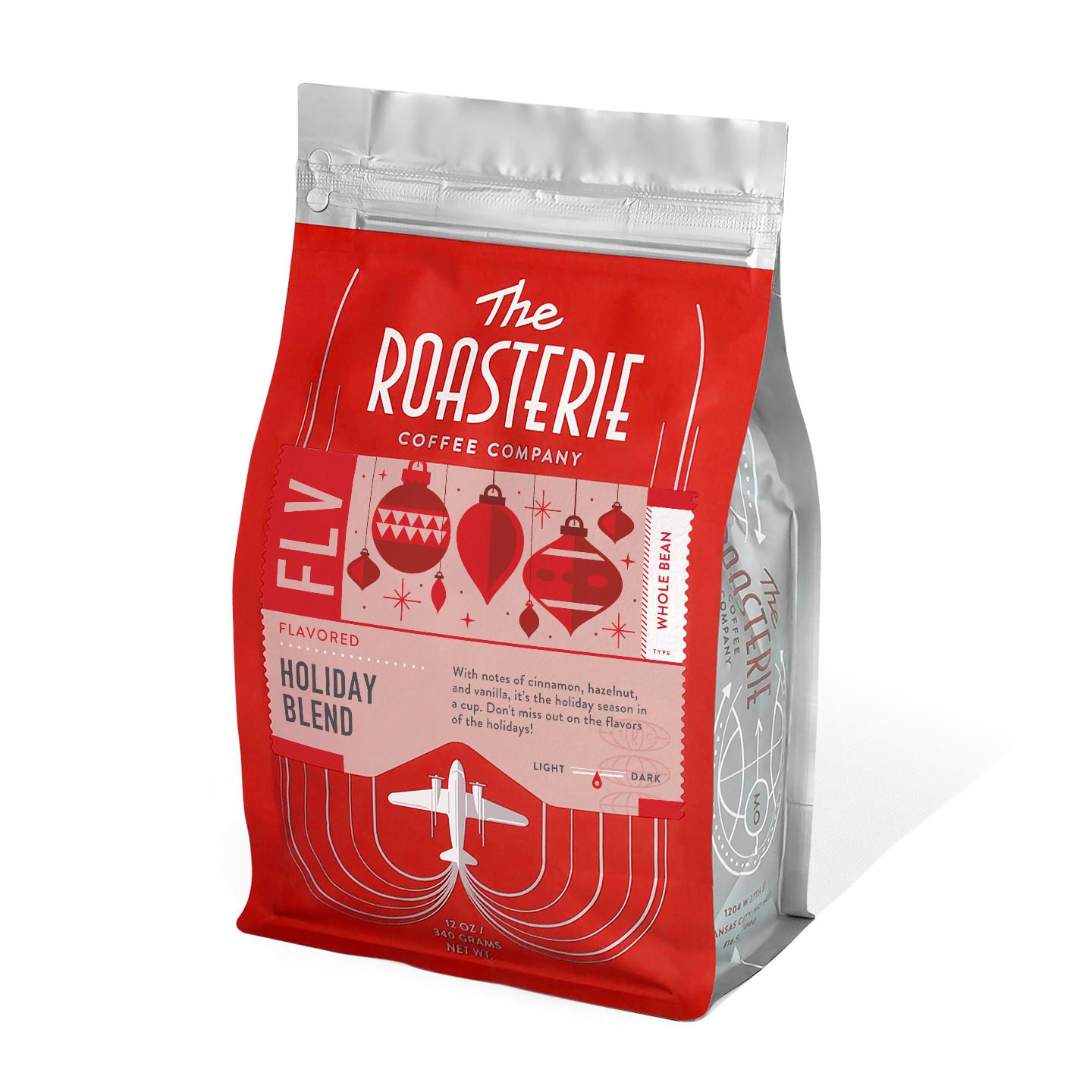 A pack of The Roasterie-Decaf Holiday Blend coffee, with red and white packaging, featuring holiday-themed graphics such as Christmas trees and a airplane.
