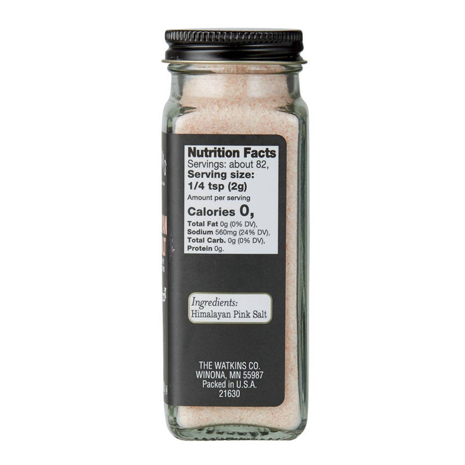 Jar of Himalayan pink salt with nutrition facts label on a white background