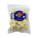 Packaged cheese curds with Alma Creamery label on a white background