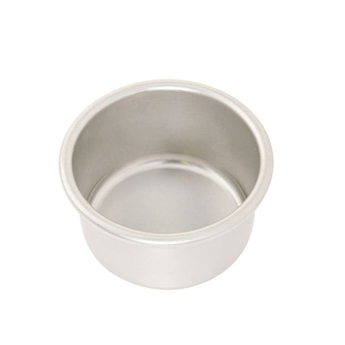 A four inch round cake pan on a white background.