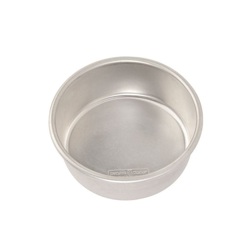 A 6 inch round Nordic Ware cake pan made of aluminum on a white background.