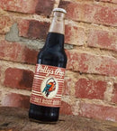 A bottle of diet root beer Polly's Pop against a brick background.