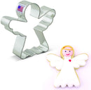 An angel-shaped cookie cutter made of stainless steel, alongside an angel-shaped cookie decorated with white icing and a red heart on its chest.