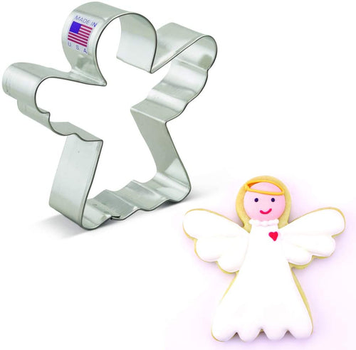 An angel-shaped cookie cutter made of stainless steel, alongside an angel-shaped cookie decorated with white icing and a red heart on its chest.
