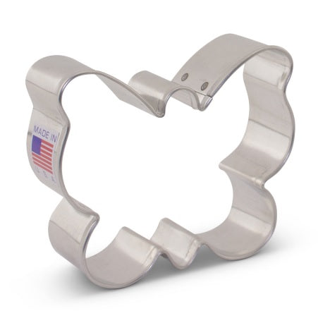 A metal butterfly-shaped cookie cutter with a flag emblem indicating it is made in the USA.