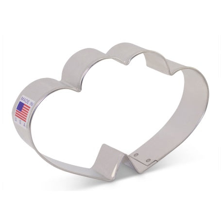 A cookie cutter shaped like two hearts coming together with a Made in America sticker.