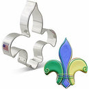 A steel cookie cutter in the shape of a Fleur de Lis, displayed alongside a colorful example of the shape used for baking.