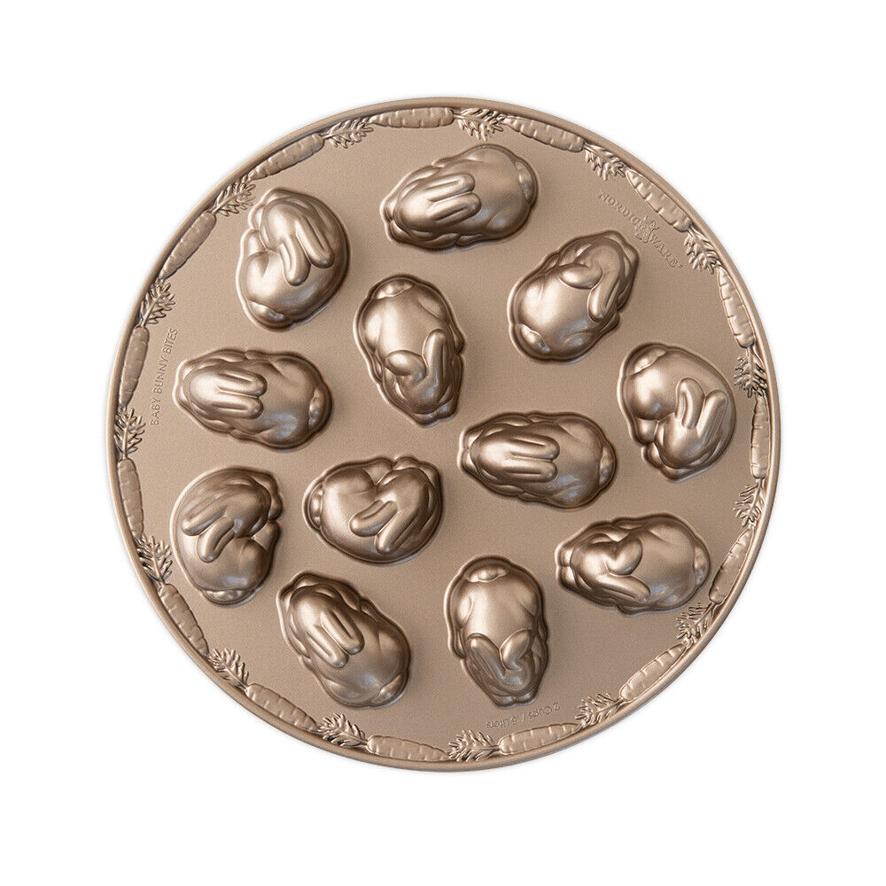 A bronze-colored Nordic Ware pan with bunny molds and featuring a ring of carrots around the edge.