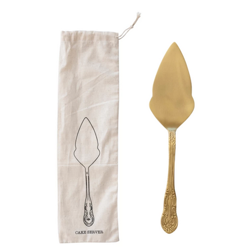 Gold cake server with a matching bag on a white background