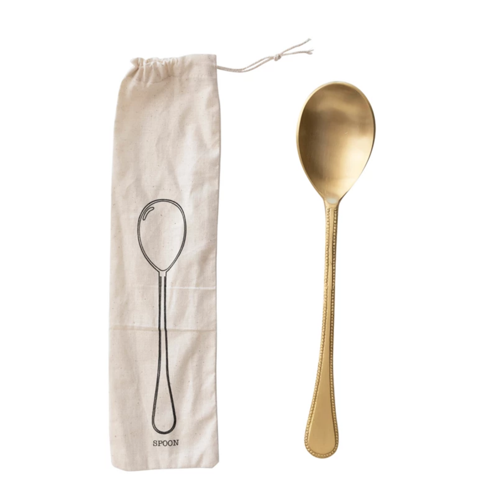 A gold-colored brass spoon placed next to a beige printed drawstring bag with a drawing of a spoon on it.