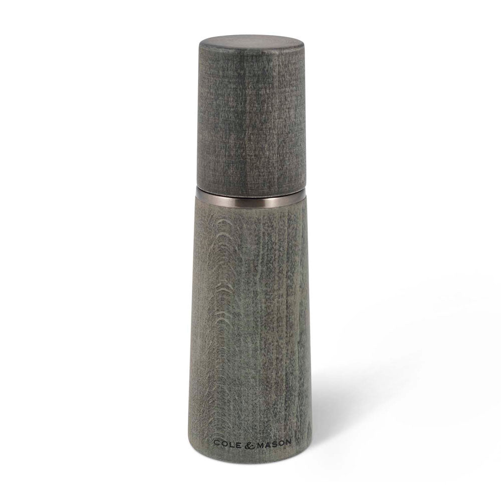 A gray wood style salt mill on a white background.