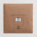 A brown paper package with a cotton half apron inside on a white background.